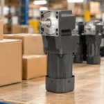 Compact AC gear motor on a factory packing bench beside plain export cartons